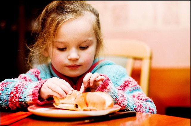 girl playing with her food